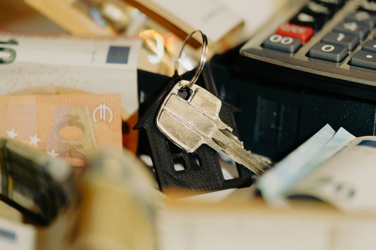 Navid Hakimi Group How Much Down Payment Do You Need in BC? (+ CMHC) 1 House keys and calculator for a down payment