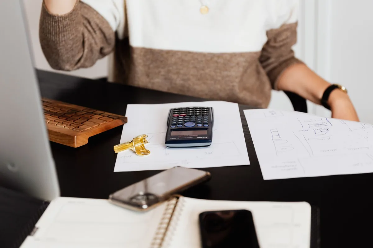 Navid Hakimi Group Is $100K Enough for a Down Payment in Vancouver? 2 Home buyer reviewing a budget with a calculator