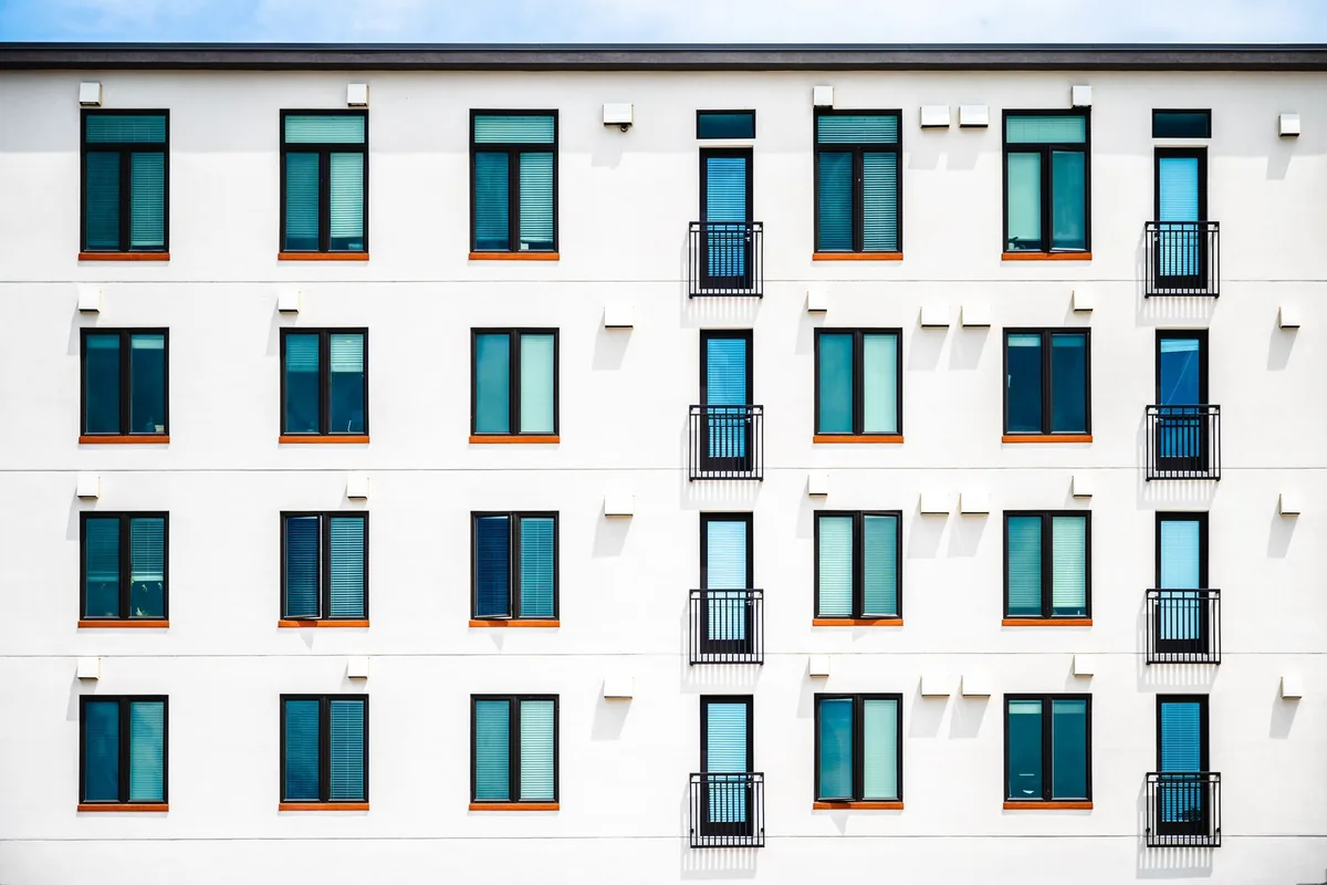 Navid Hakimi Group Is $100K Enough for a Down Payment in Vancouver? 1 Modern condominium exterior in an urban neighbourhood