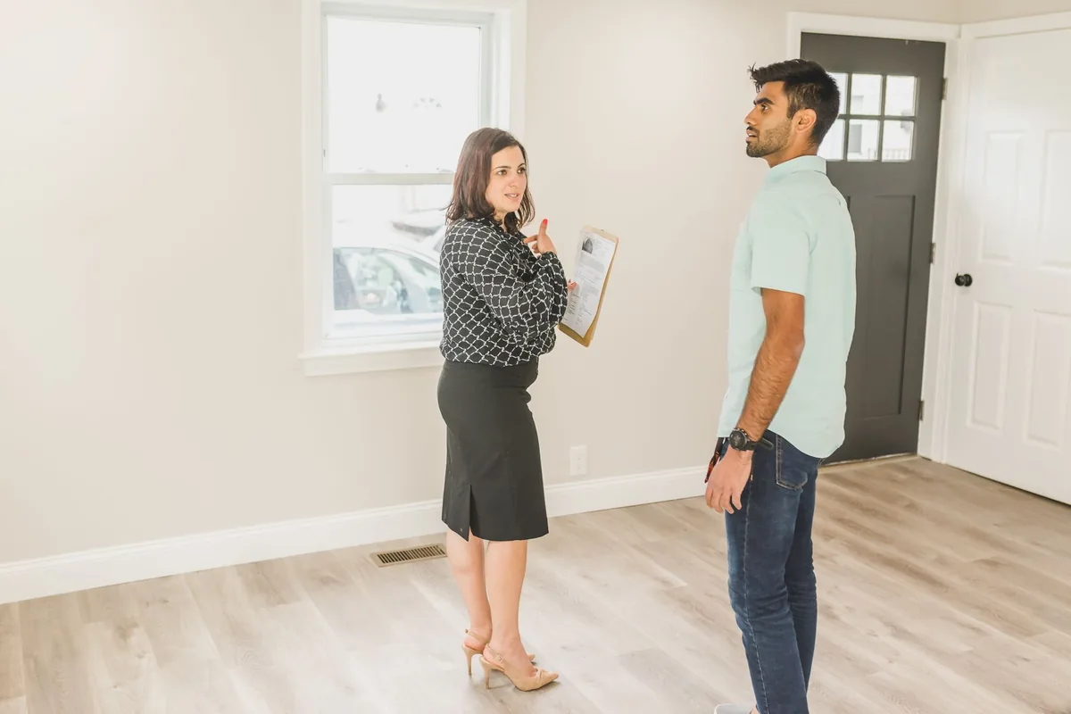 Buyer and real estate agent inspecting a home interior