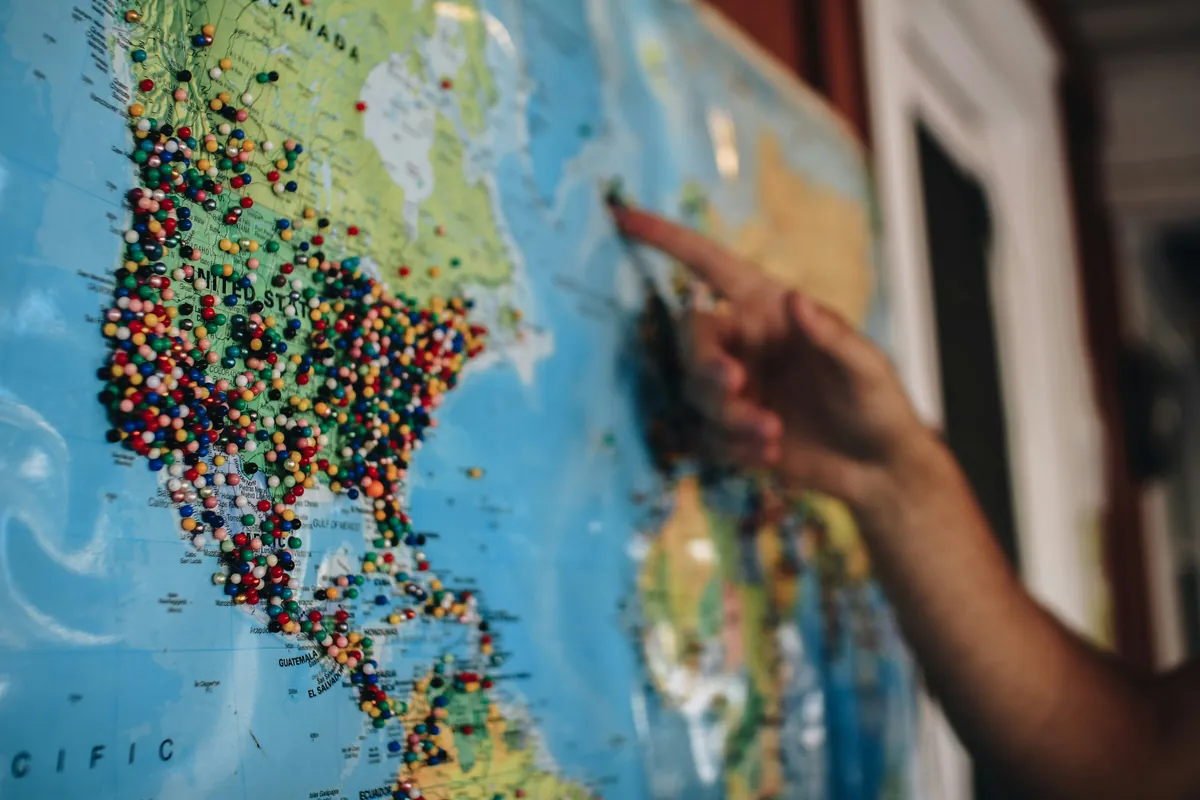 Hand pointing to locations on a map