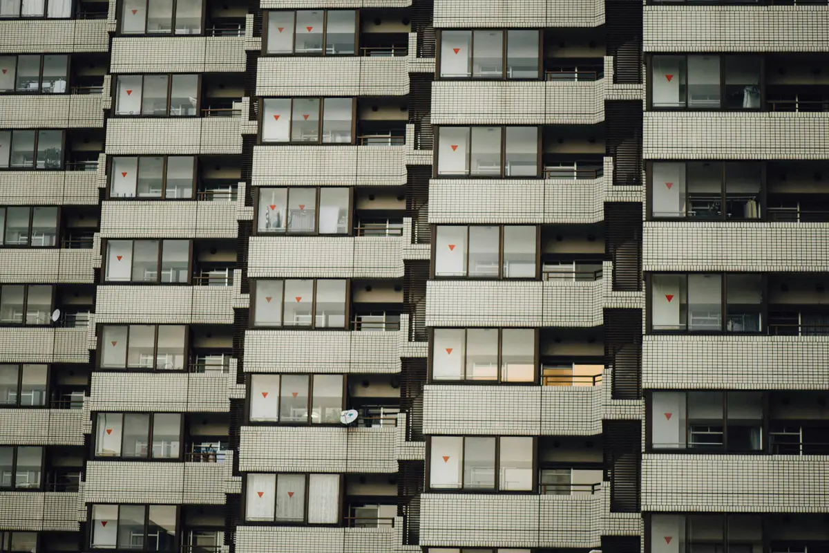 White condominium building with repeating balconies