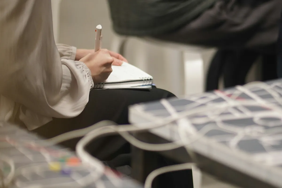 Person taking notes during a meeting