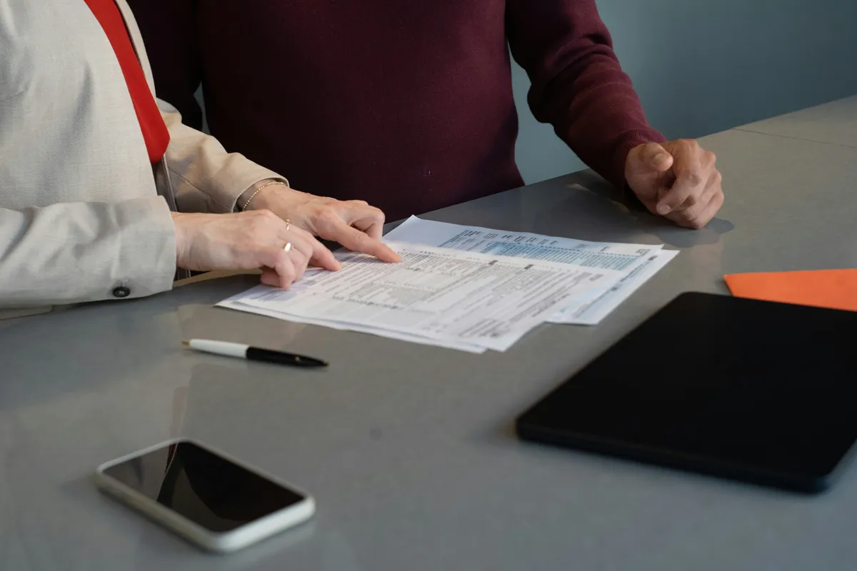 Two people reviewing property documents at a table