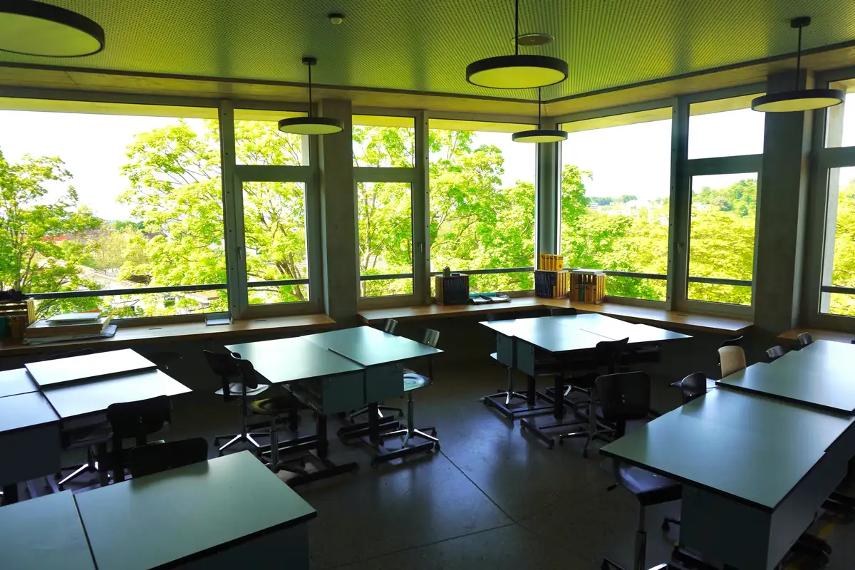 Bright school classroom with desks and windows