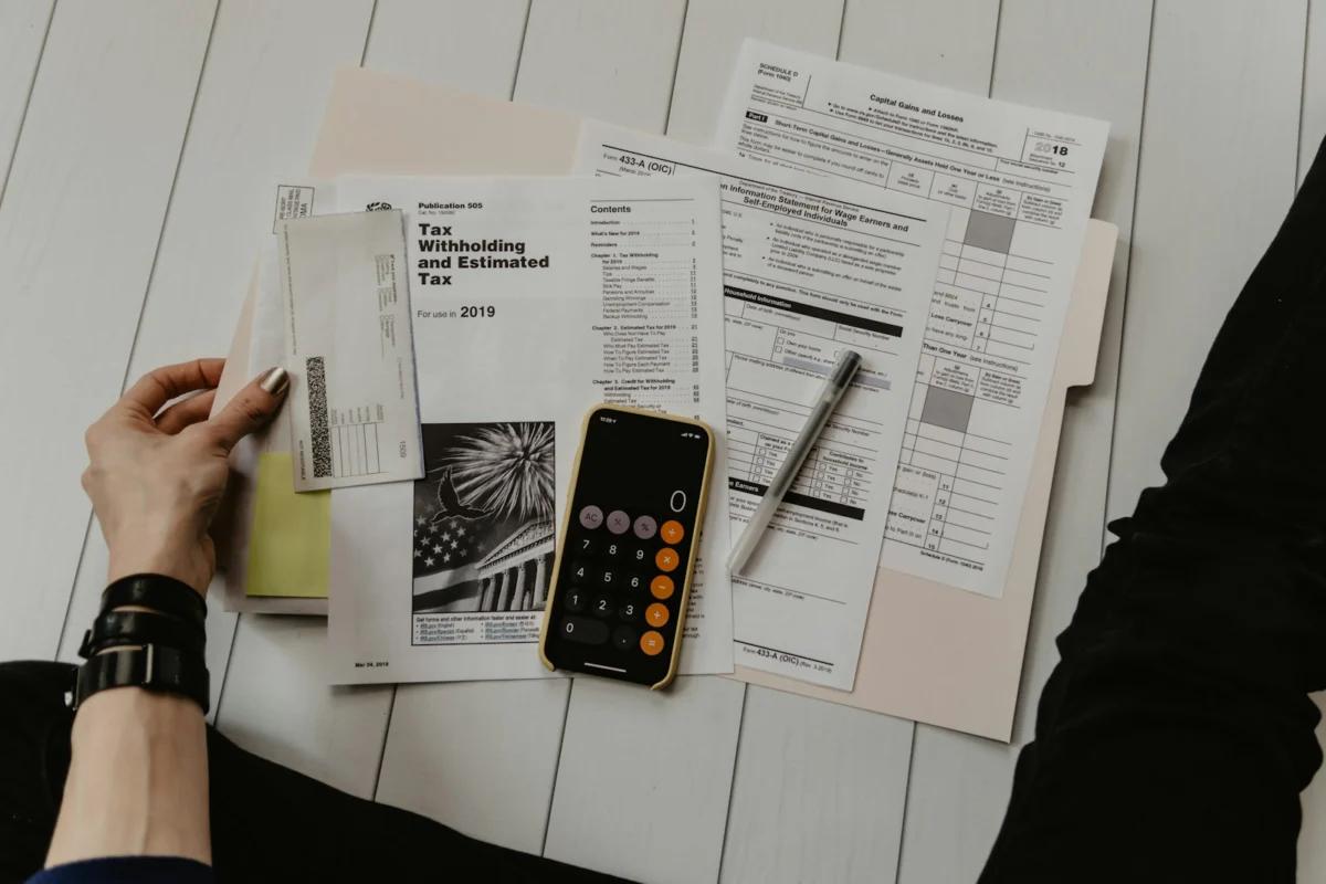 Financial paperwork and a calculator for reviewing homeowner eligibility