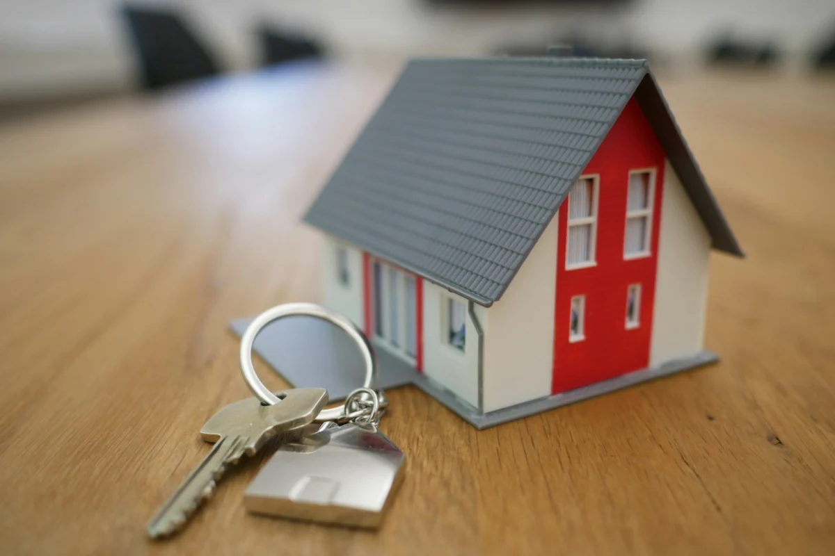 House keys beside property ownership documents