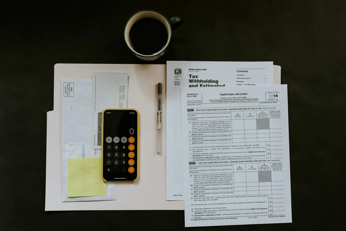 Calculator and financial documents used to compare mortgage costs