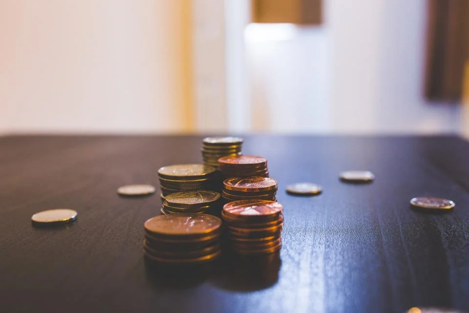Navid Hakimi Group How to Sell Your House Fast in Vancouver | 5 Options Compared 2 Stacks of coins on a table, representing a cash offer