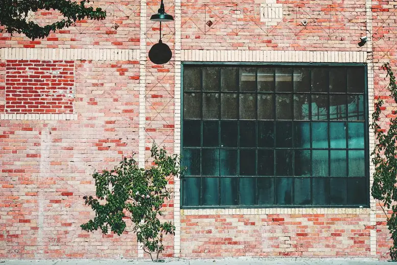 Brick commercial building with large industrial windows ready for a condition review