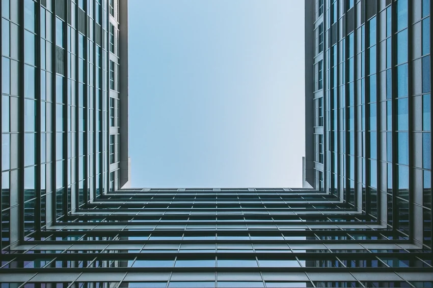 Looking up at a glass office tower, one of the commercial property types buyers consider