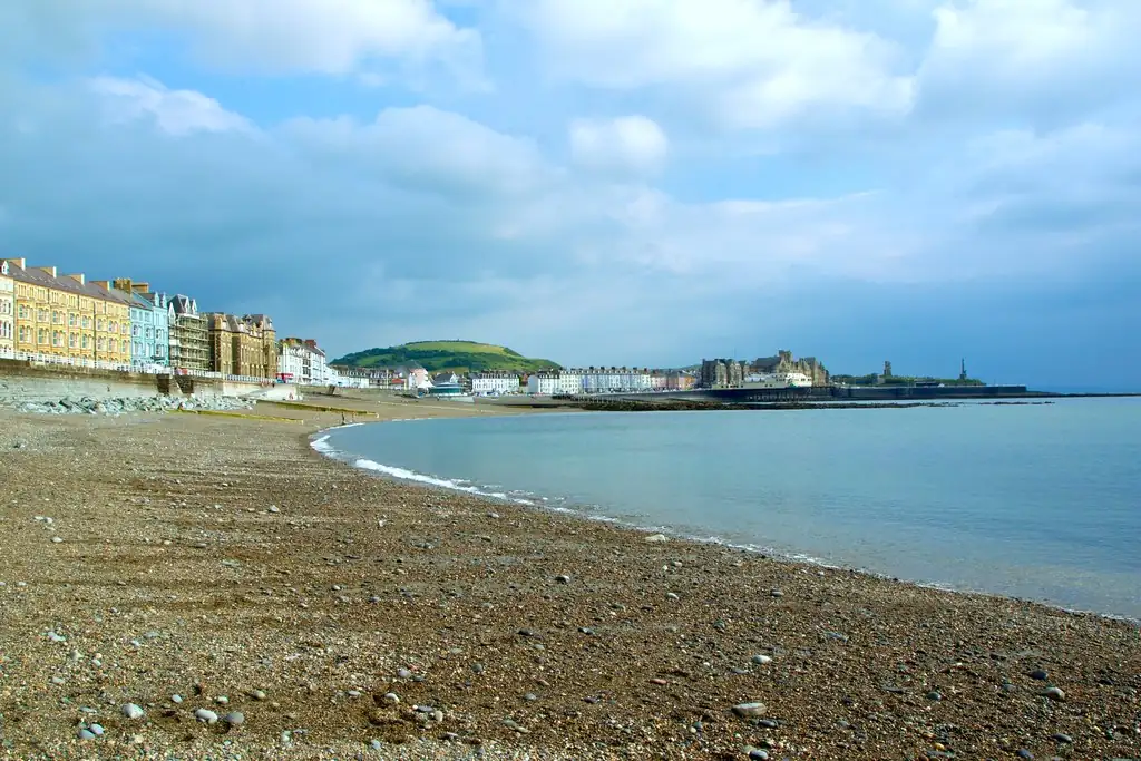 Quiet pebble beach curving along a seaside village waterfront