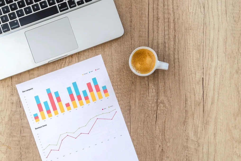 Navid Hakimi Group Why Is My House Not Selling? 9 Reasons and How to Fix Them 3 Printed market chart beside a laptop and a cup of coffee