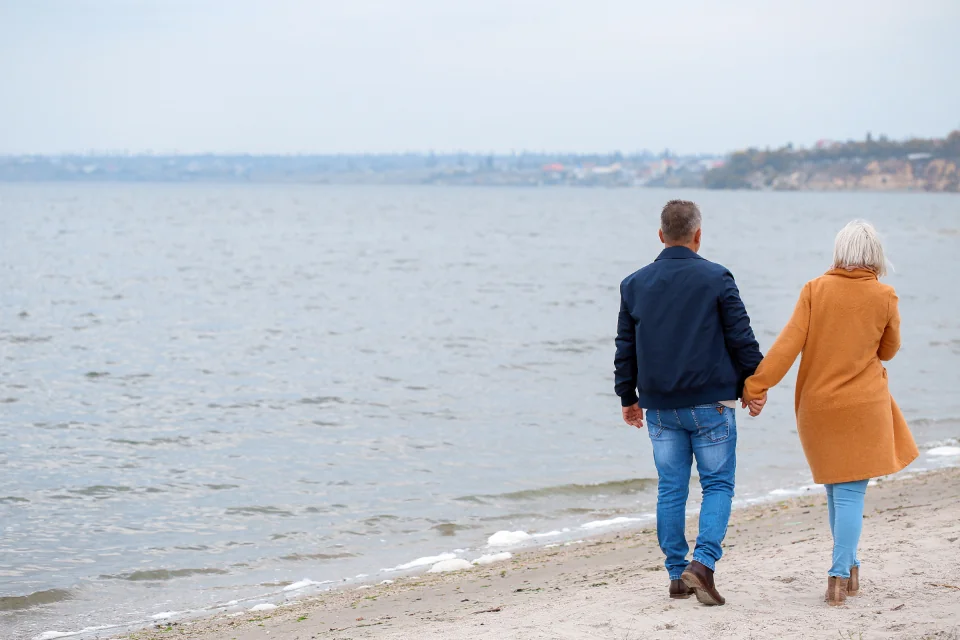 Senior couple walking together along a beach