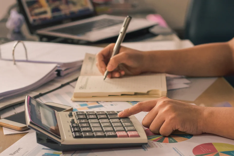 Owner using a calculator to budget for a strata special levy payment