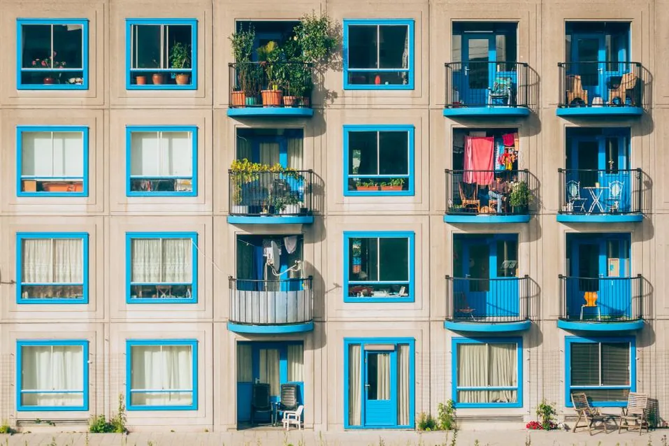Apartment building facade with rows of balconies and windows
