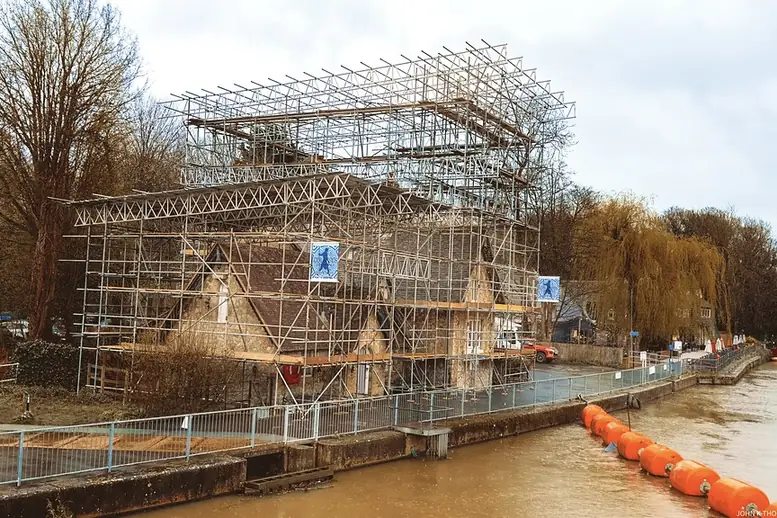 Building wrapped in scaffolding during major exterior repairs