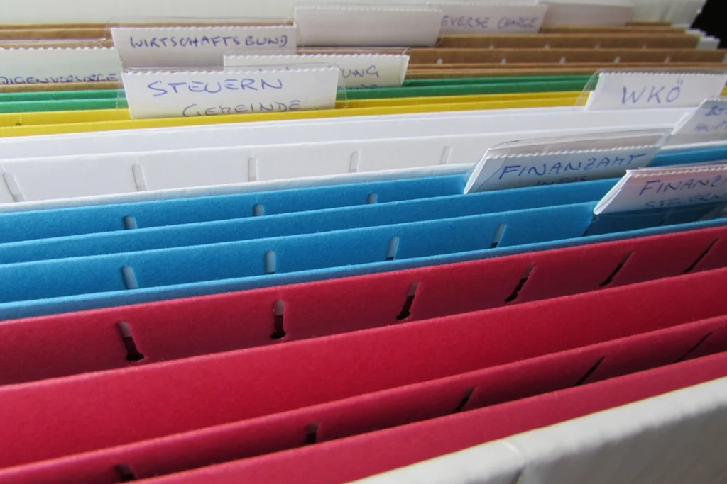 Labelled file folders holding strata documents and meeting minutes