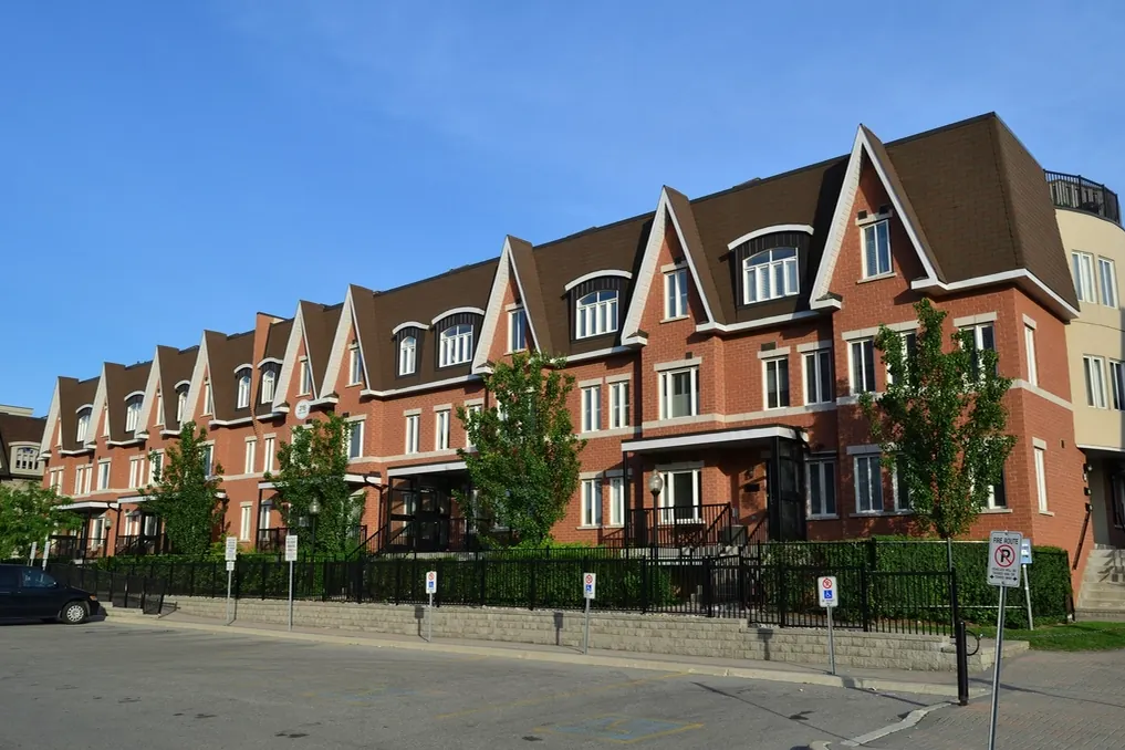 Navid Hakimi Group North Vancouver Townhouses | Prices, Best Areas and What to Check 1 Row of brick townhouses with peaked gables along a residential street