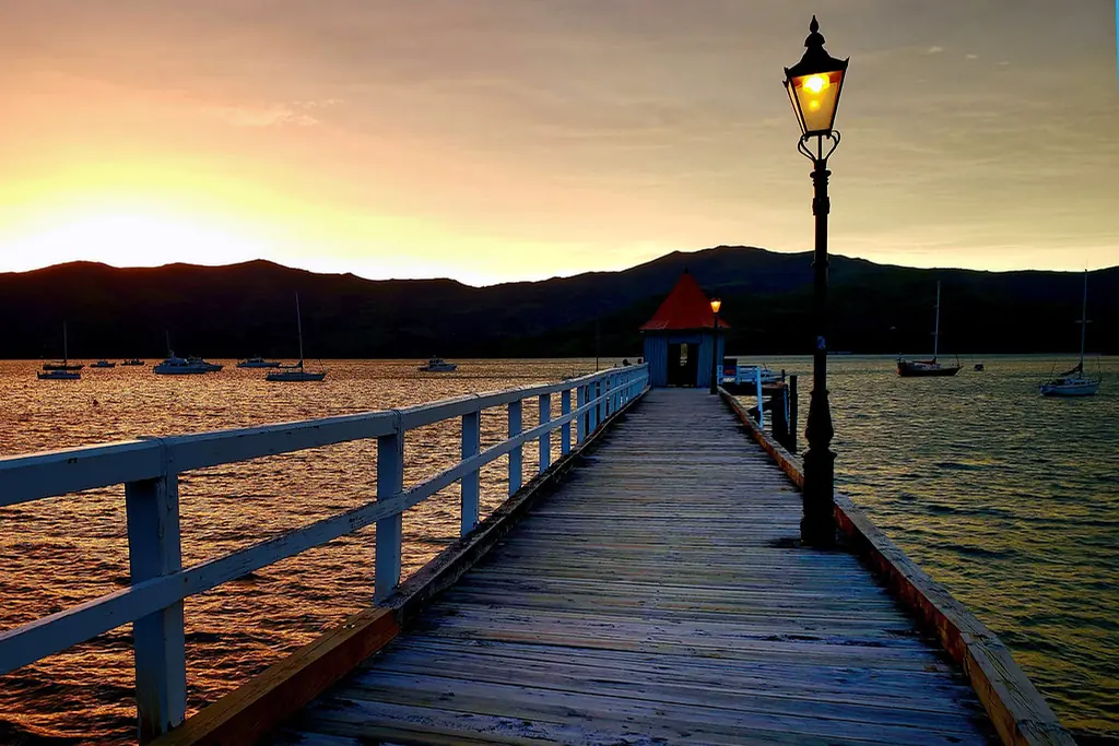 Navid Hakimi Group Living in Lower Lonsdale | A Buyer's Guide to North Vancouver's Waterfront Core 3 Wooden pier with a lamp post at sunset over the water